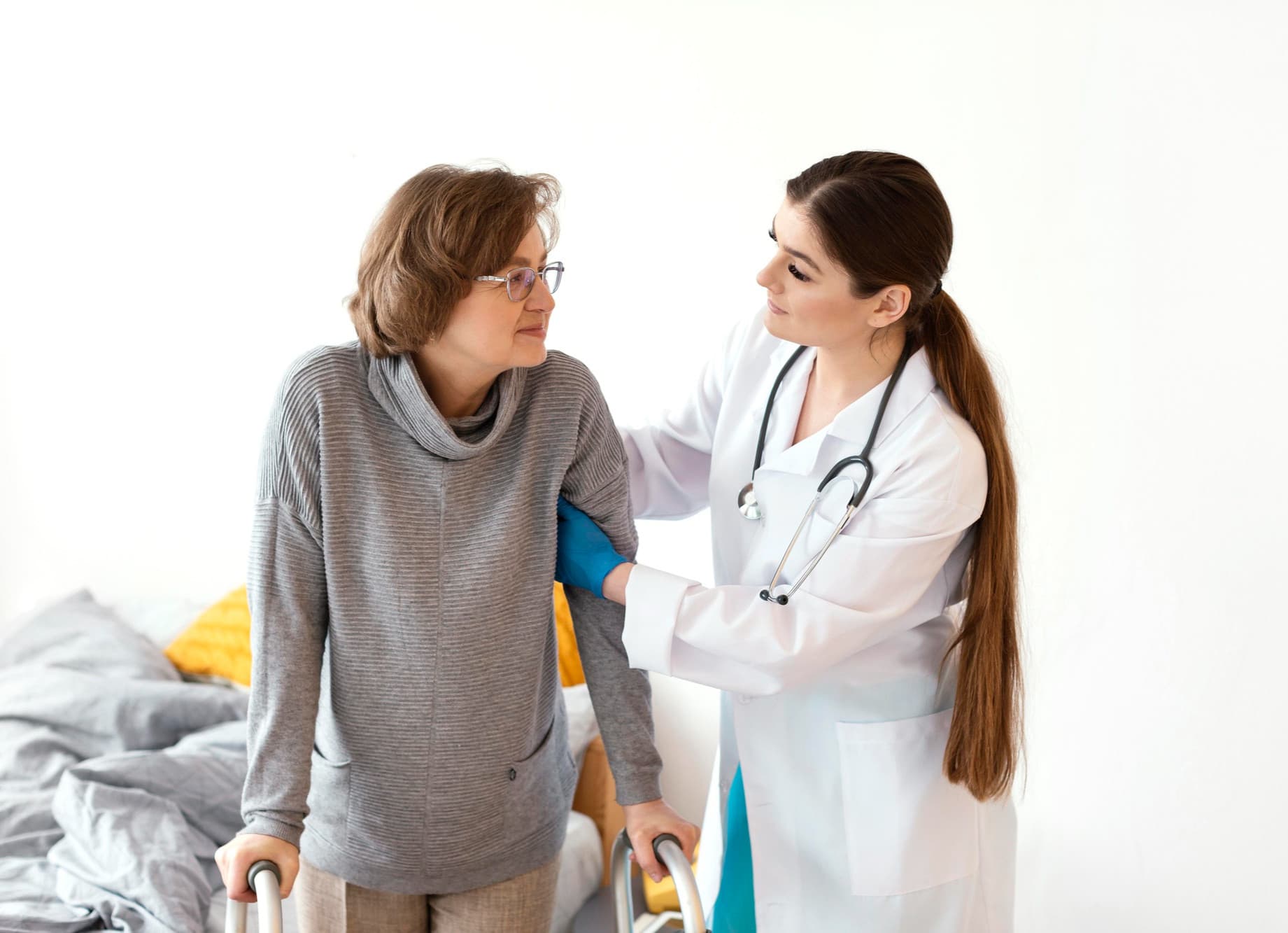 Physician supporting an older woman’s arm