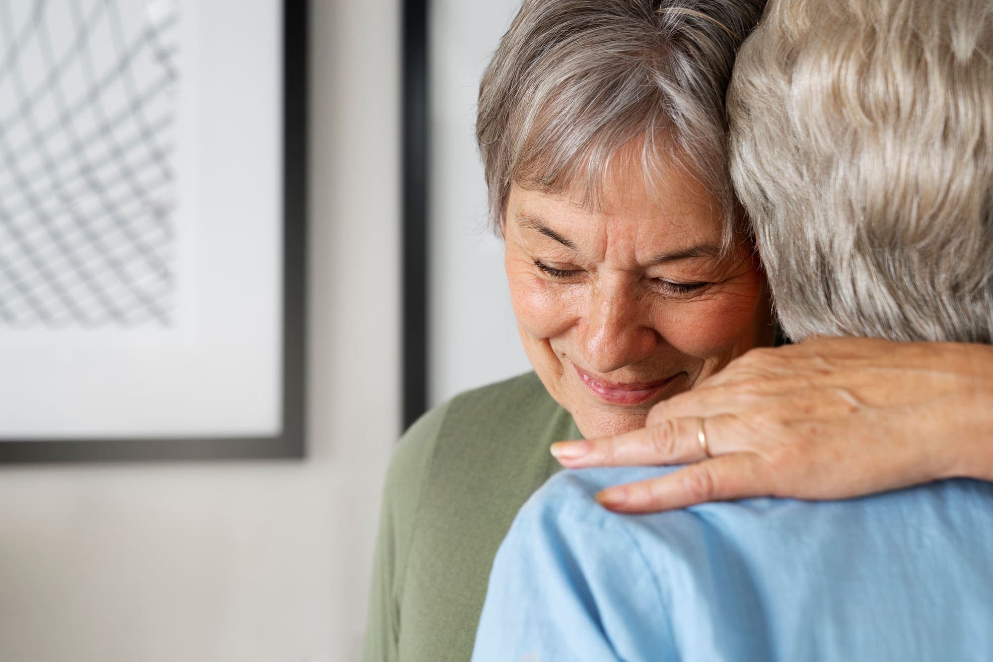 Smiling older woman hugging a loved one