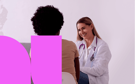 Smiling provider talking with a patient during a visit