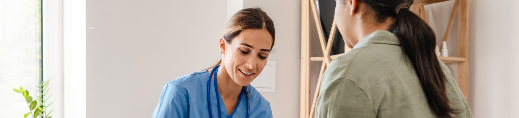 Nurse smiling while talking with a patient